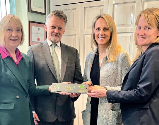 From left Carolyn Day, of Greener Globe Funeral Standard, presents Levertons & Sons' team members Andrew, Hannah and Pippa Leverton with their Greener Globe Funeral Standard Gold plaque